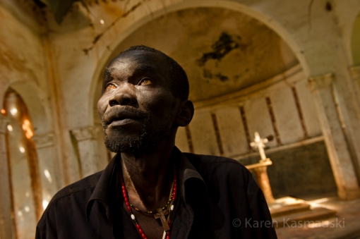 Paustino Jada, the catechist  of the Palotaka Church in South Sudan looks up at the damage ceiling.