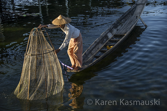 Fisherman collects his net on Myanmar's Inle Lake.